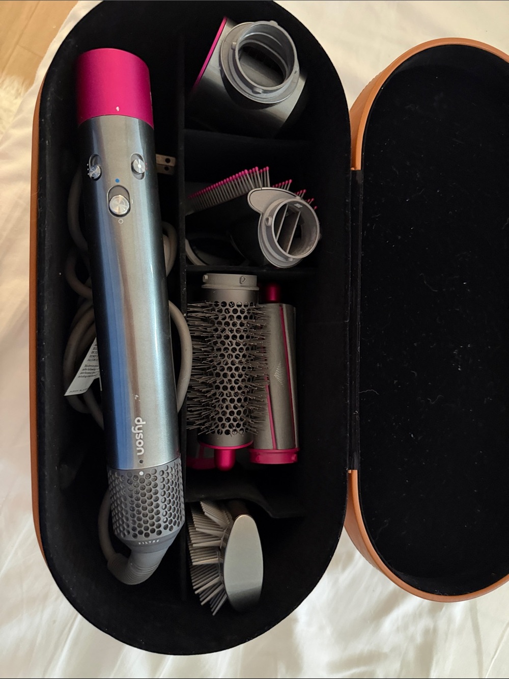 Dyson multi-attachment styler in Gunmetal and Pink